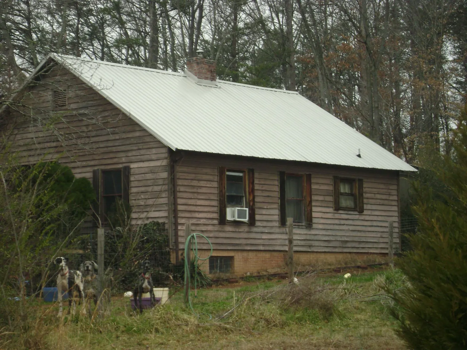 White metal roof on an old wood sided farmhouse, from a Asphalt Shingle Roof Repair job in Fall River
